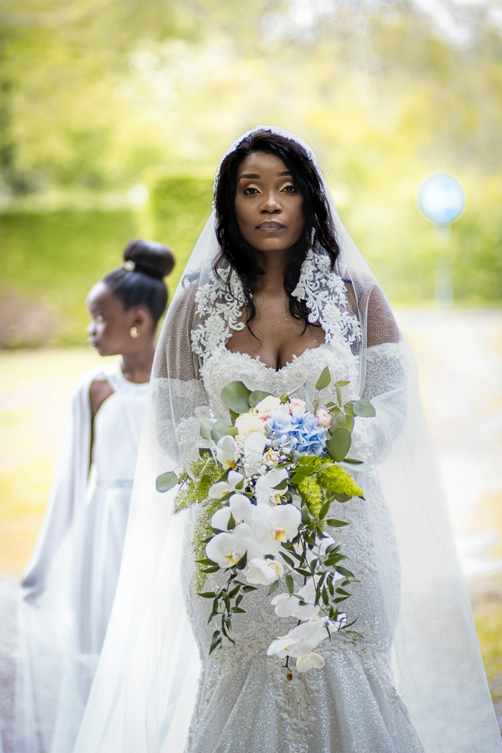 a woman in a white dress holding a bouquet of flowers