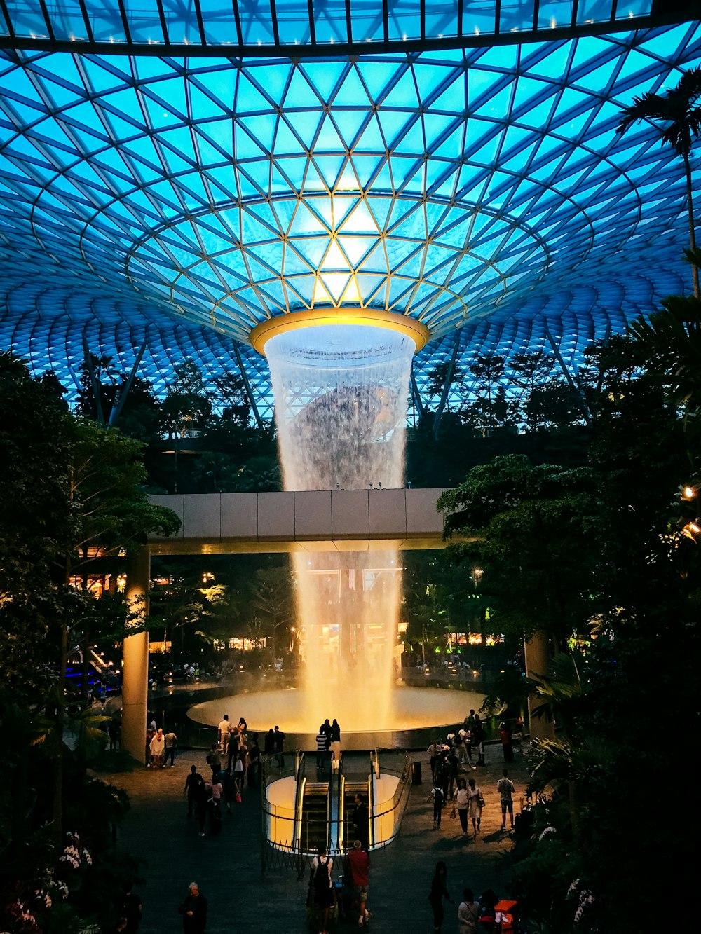 a large glass dome with people walking around
