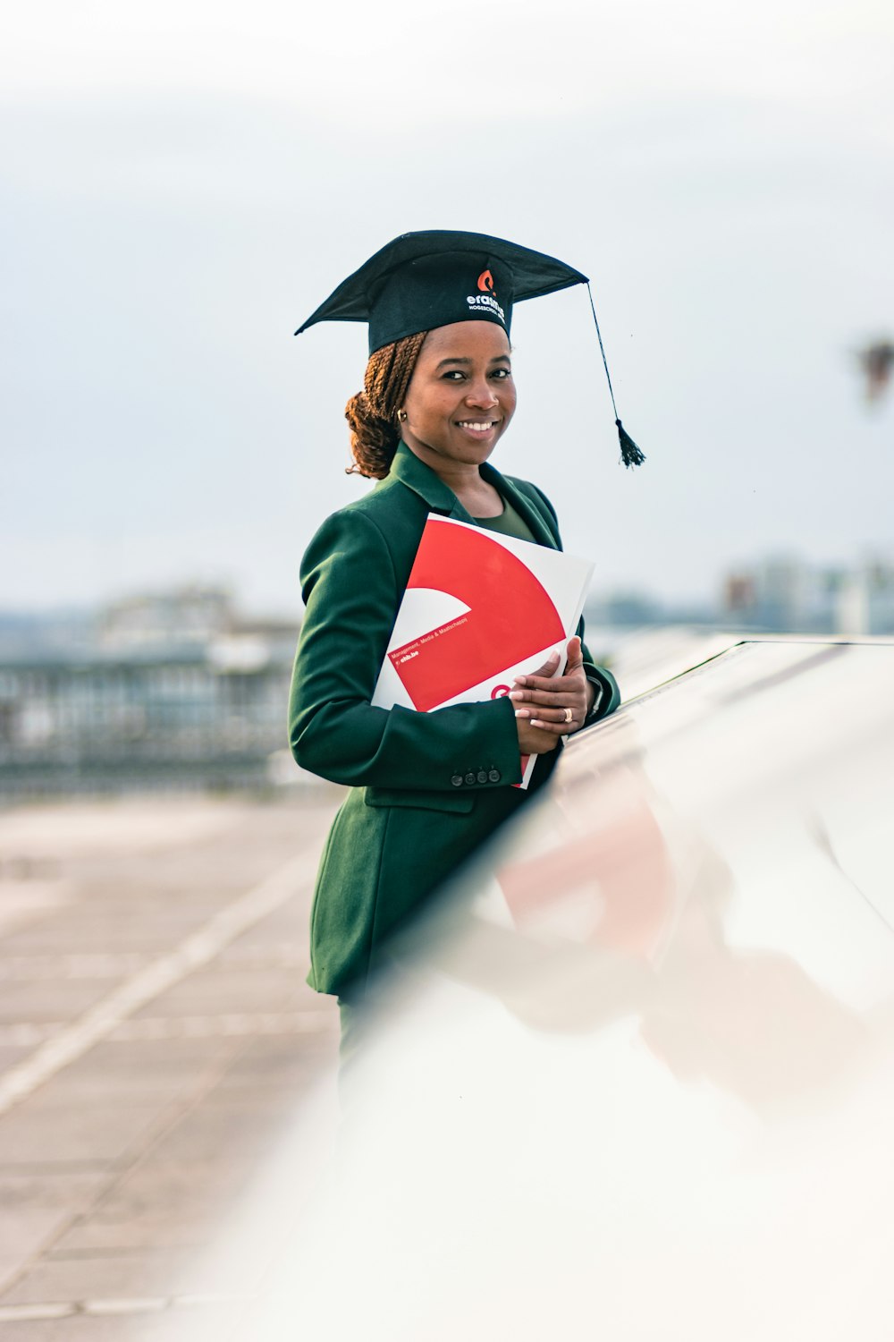 a person in a graduation gown holding a diploma and a diploma