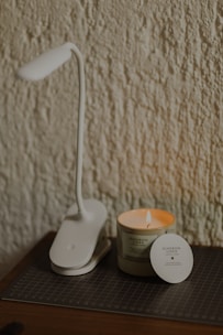 a white coffee maker next to a coffee cup