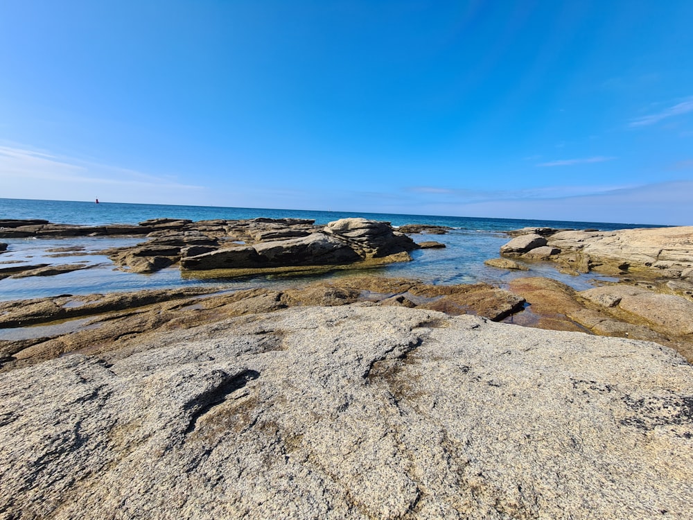 a rocky beach with blue sky