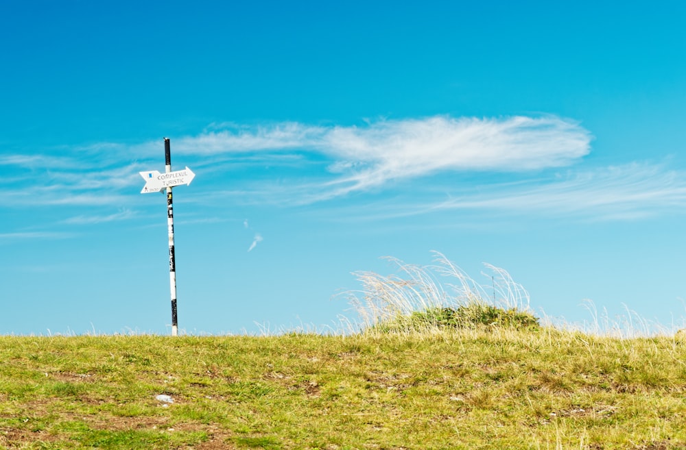 a windmill on a grassy hill
