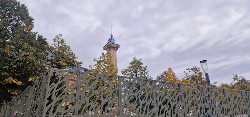 a fence with a tower in the background