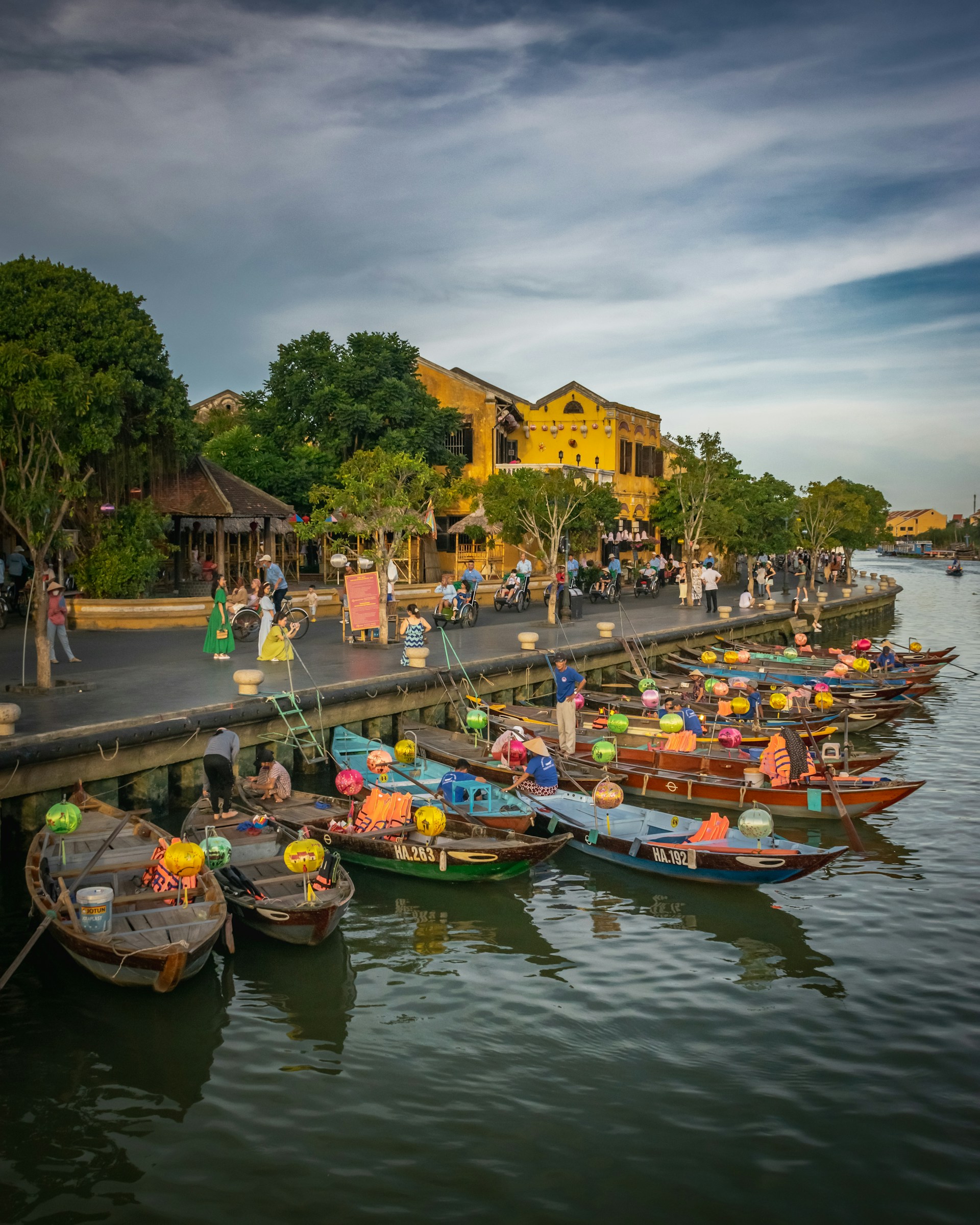 a group of boats are parked on the side of a river