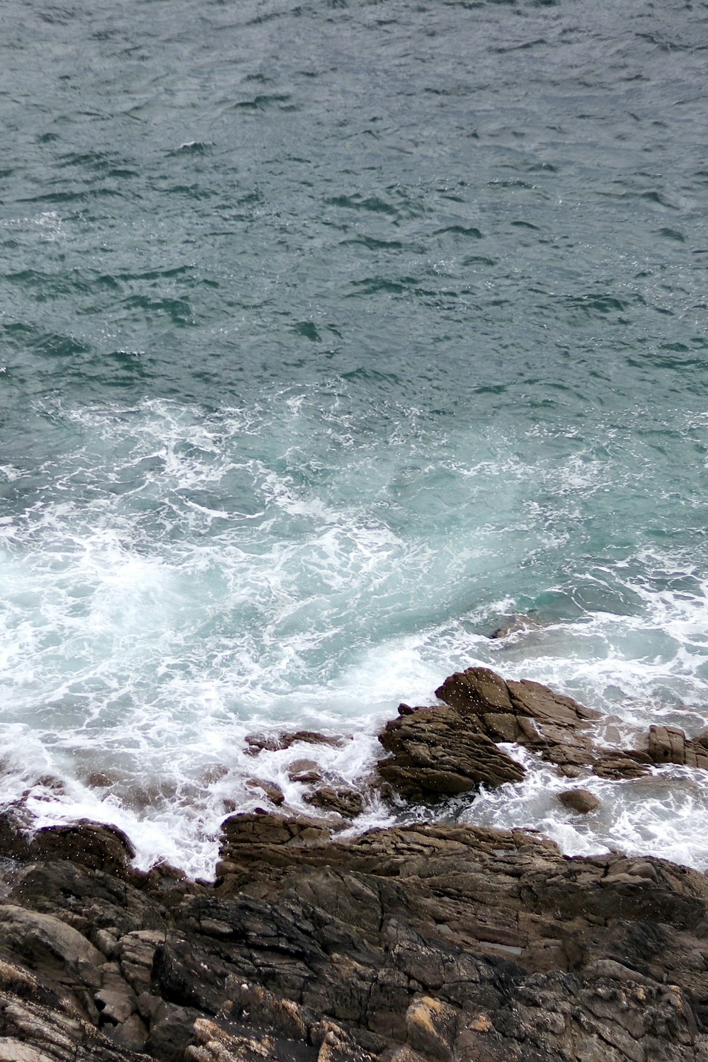 a rocky beach with waves crashing