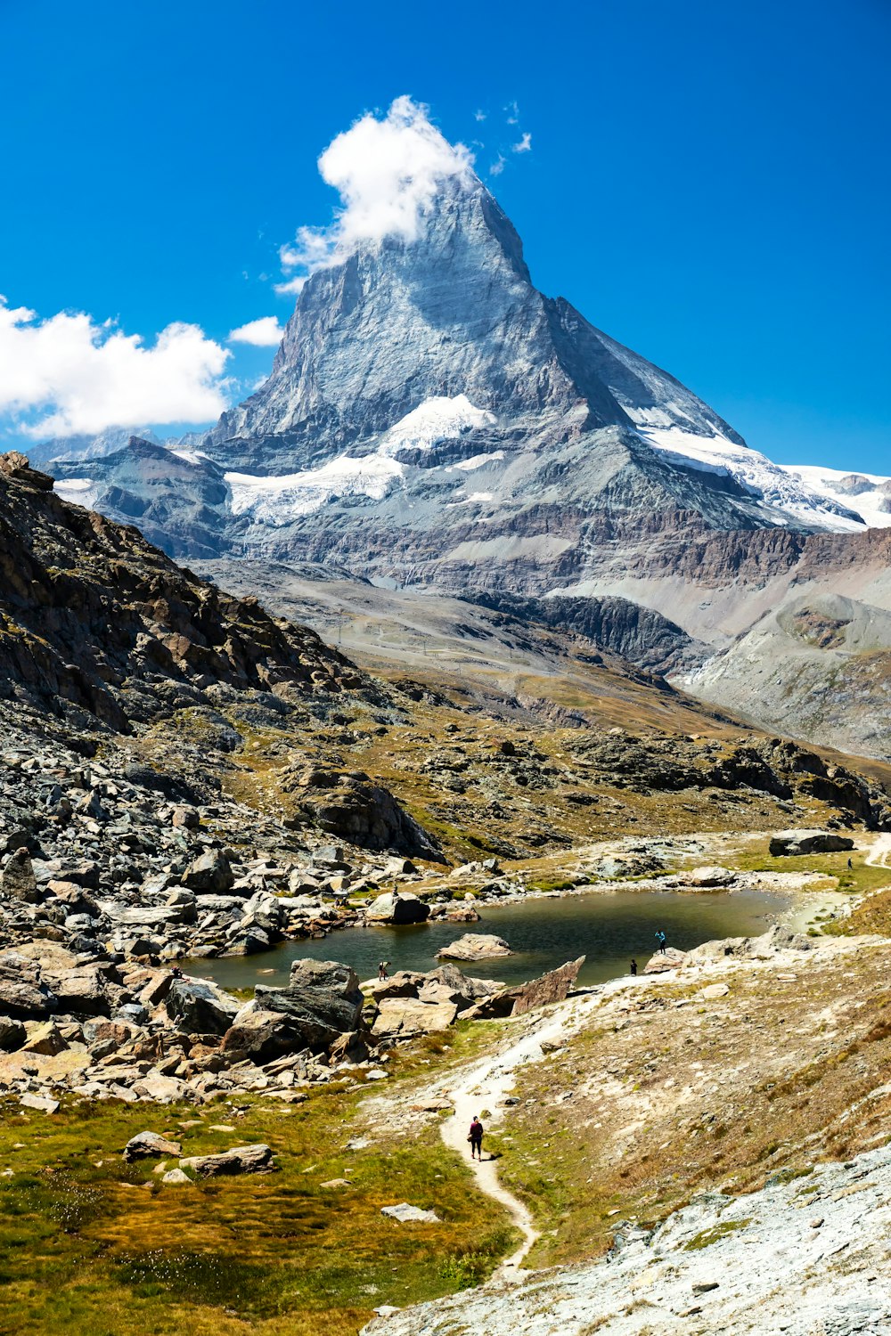 a mountain with a stream running through it