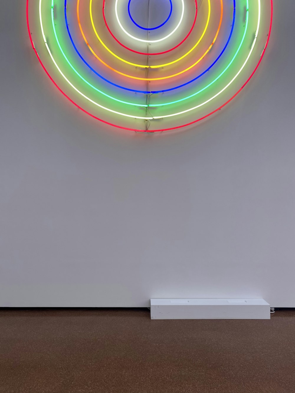a rainbow colored circle on a wall