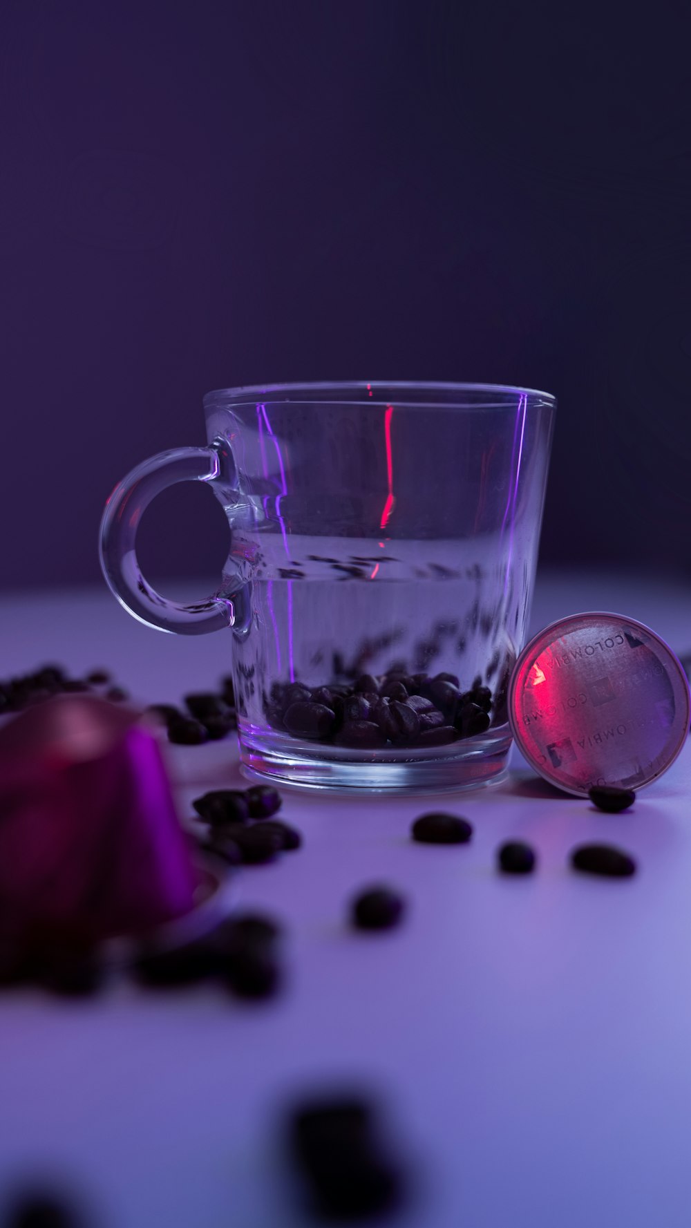 a glass of water with a red liquid in it