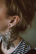 a woman with a tattoo on her ear