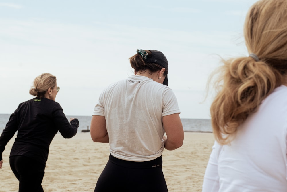 a group of women walking on a beach