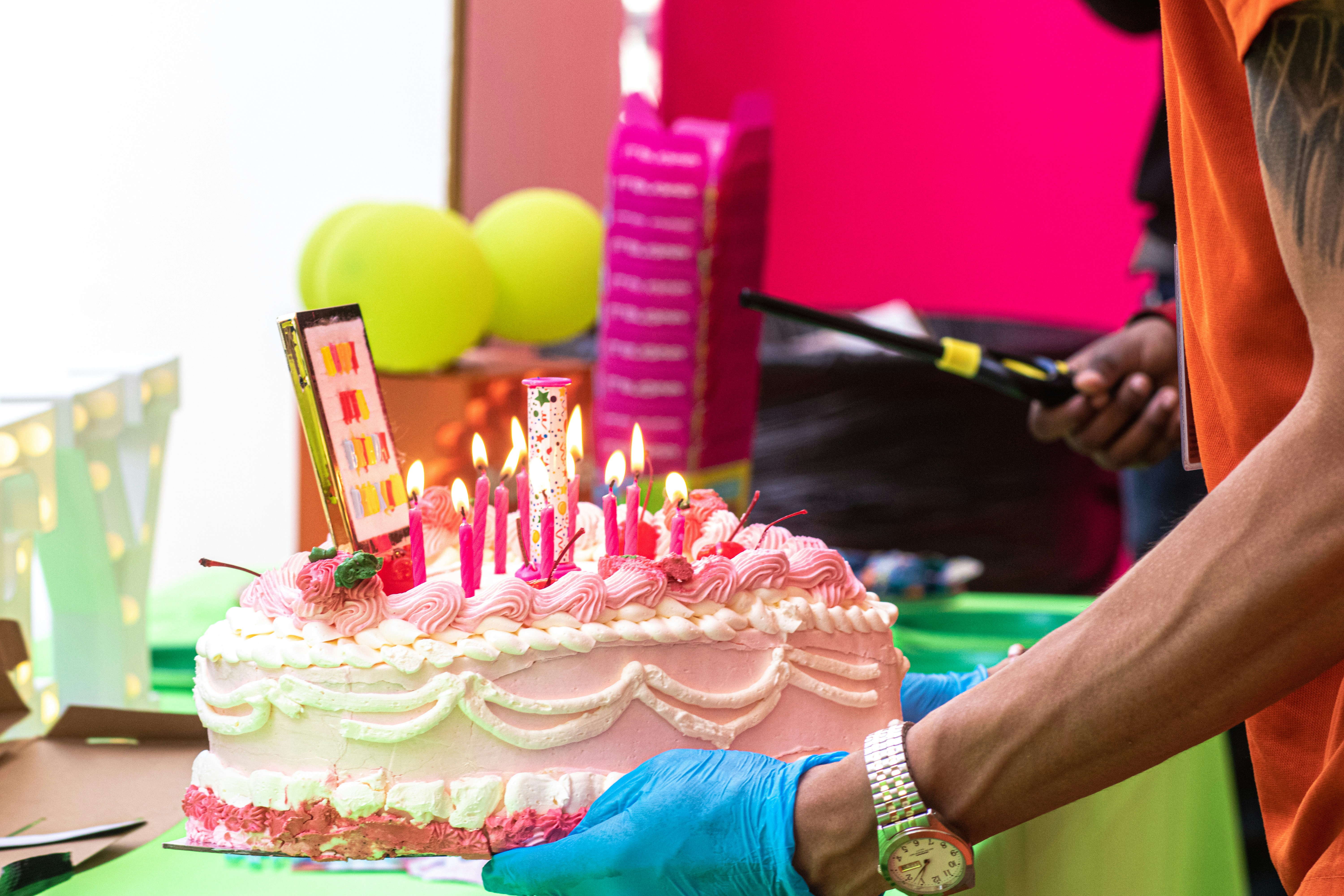 a person cutting a cake