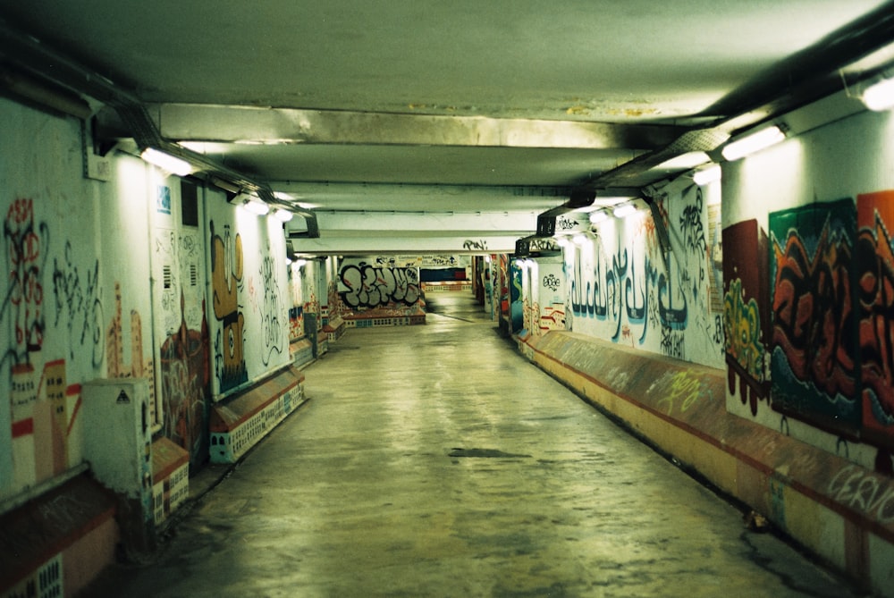 a hallway with graffiti on the walls