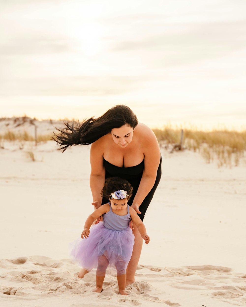 a person and a baby on a beach