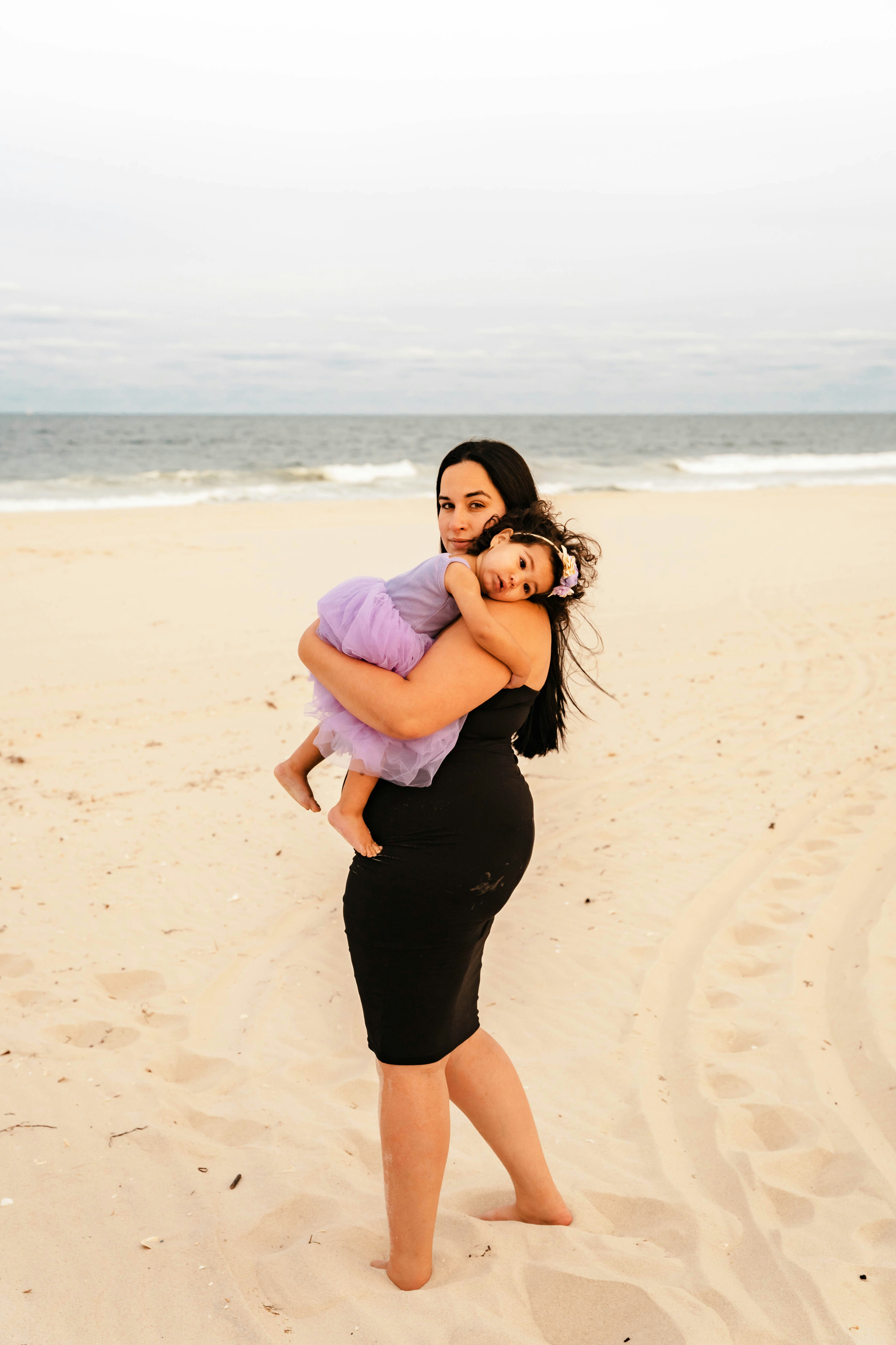 a man and woman hugging on a beach
