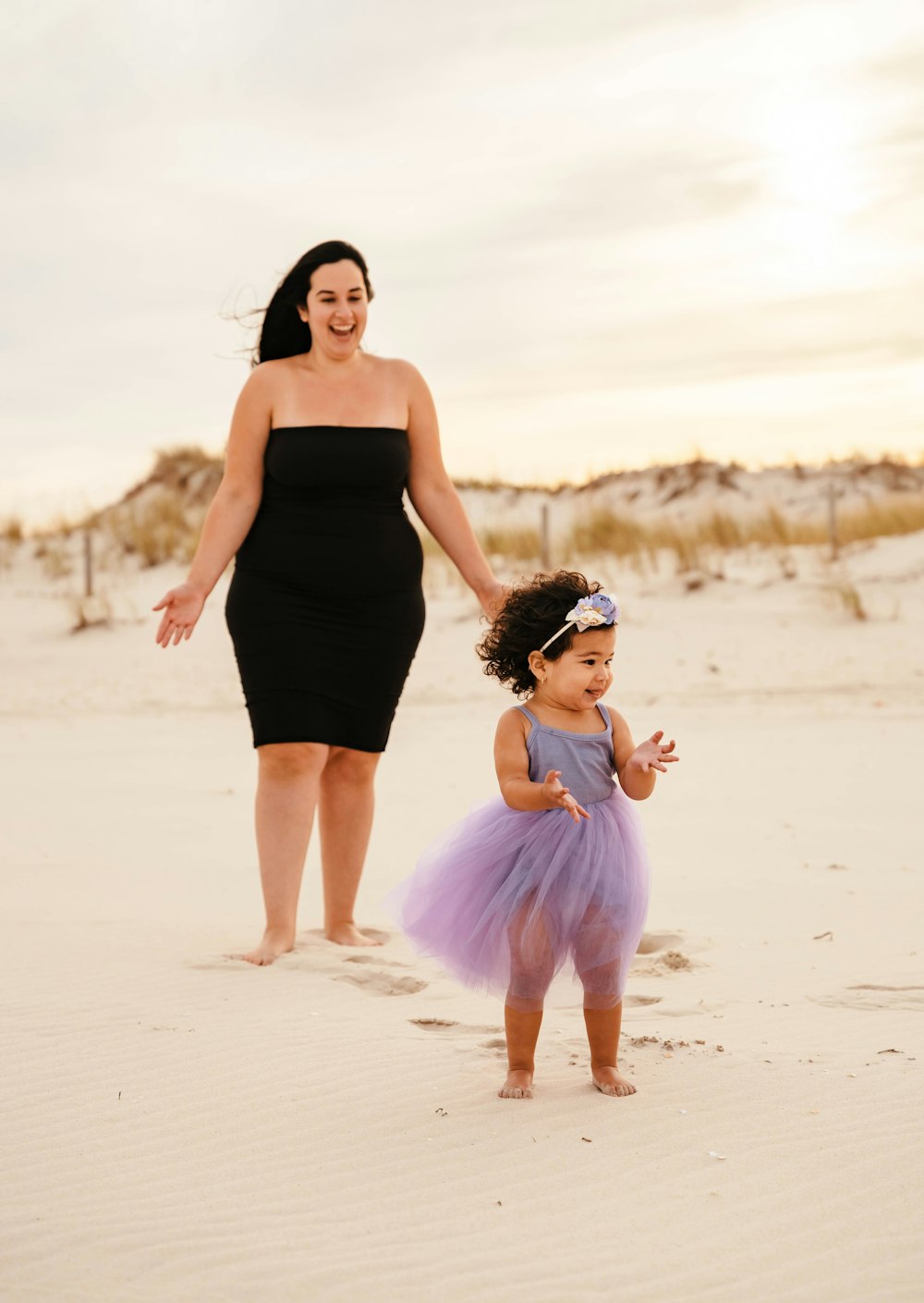 a woman and a child on a beach