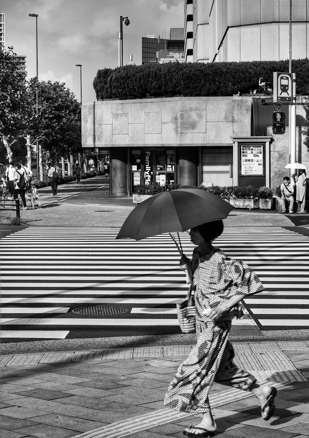 a woman walking down the street with an umbrella