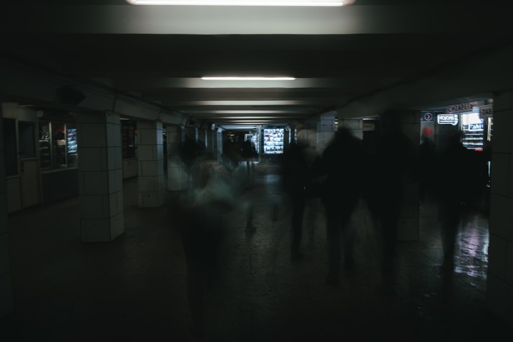 a group of people walking in a dark room