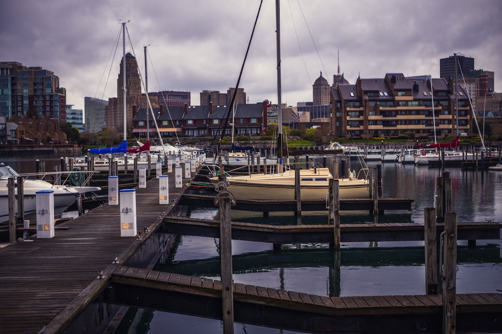 a dock with boats and buildings in the background