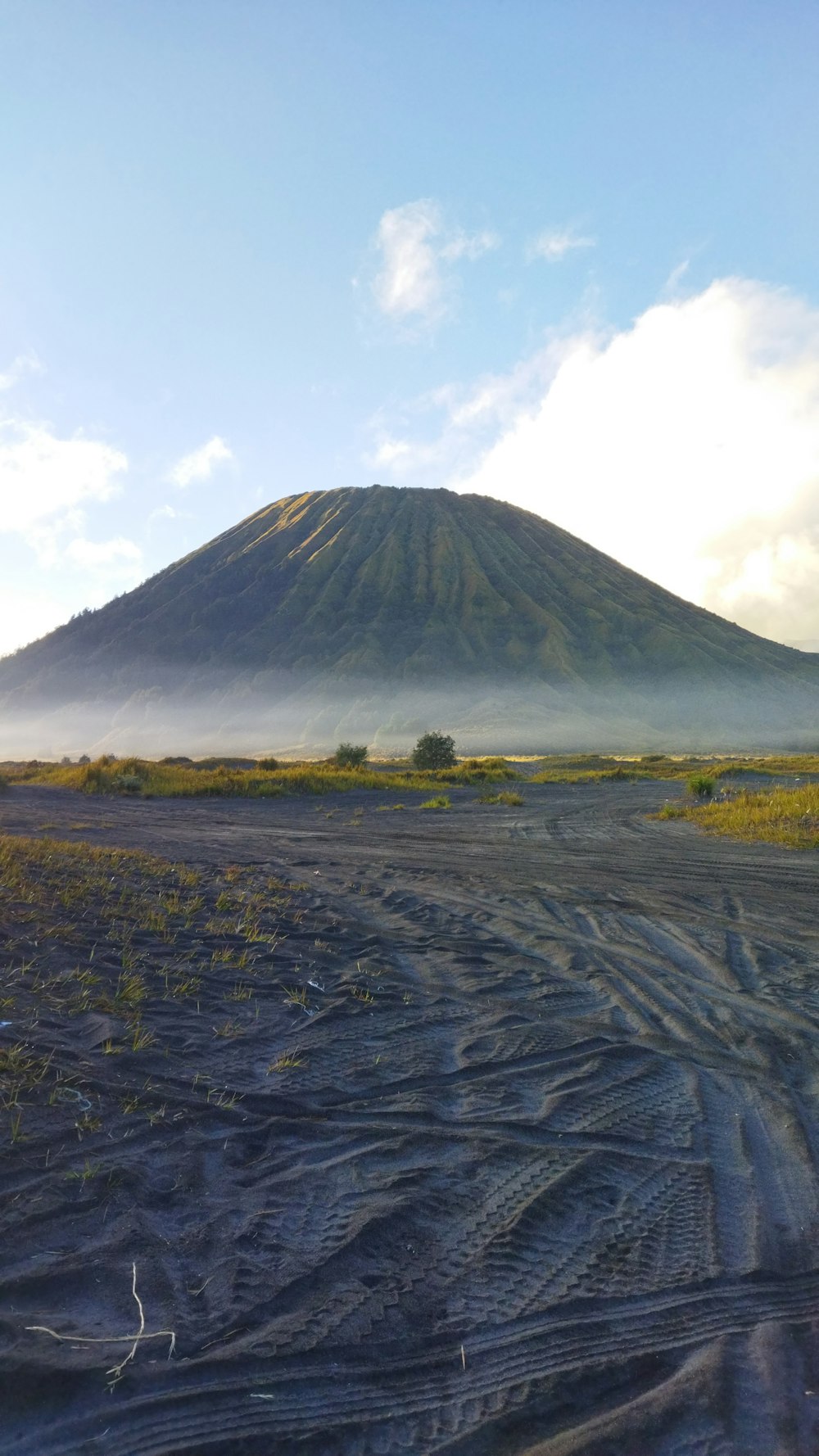 a large flat area with a mountain in the background