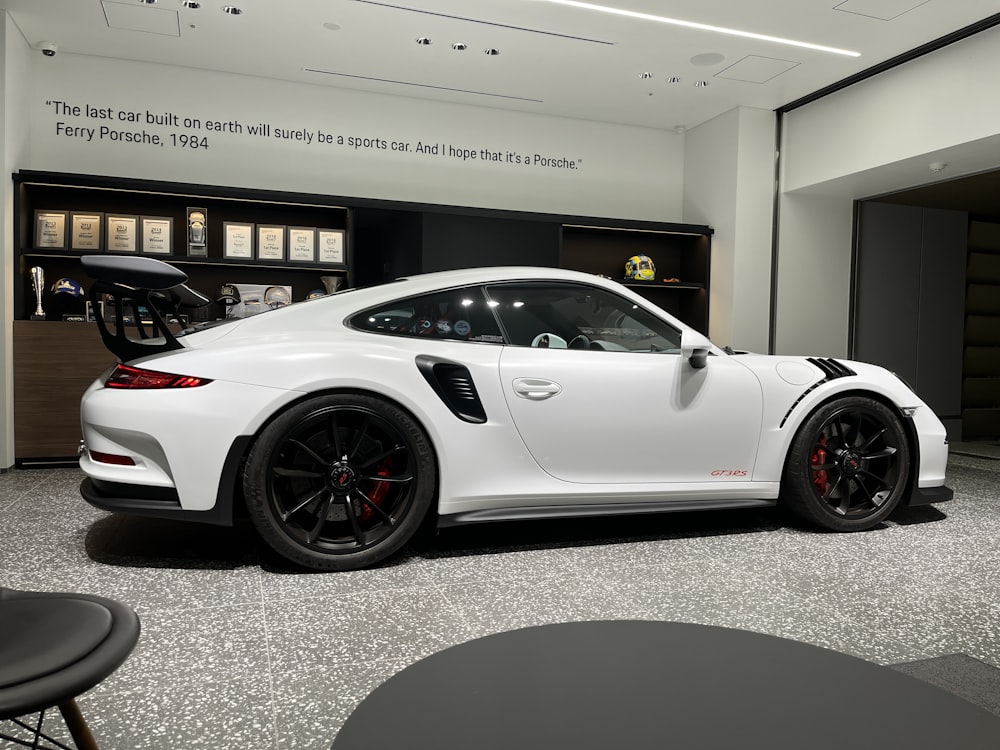 a white sports car in a showroom