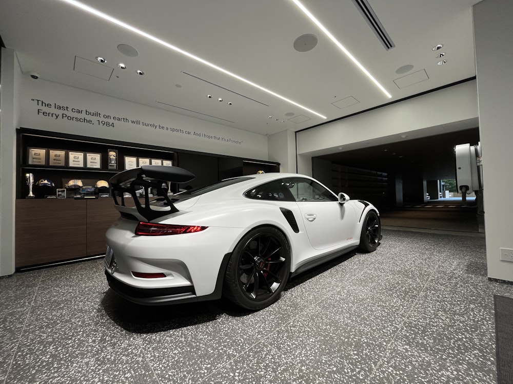 a white sports car in a building