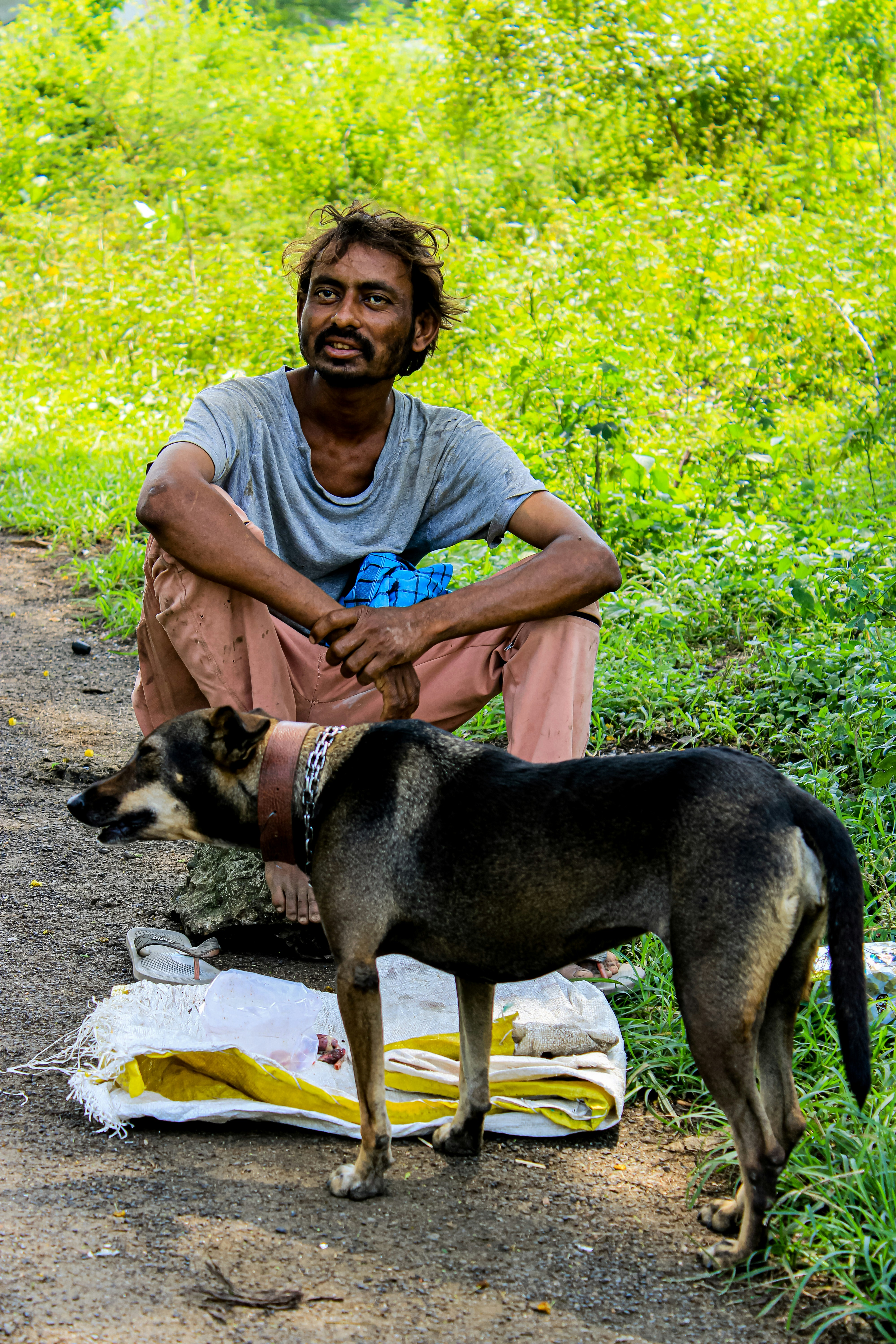 a man sitting on a chair with a dog