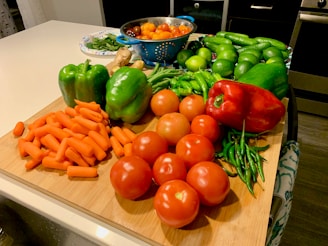 A vibrant assortment of fresh vegetables on a wooden cutting board.