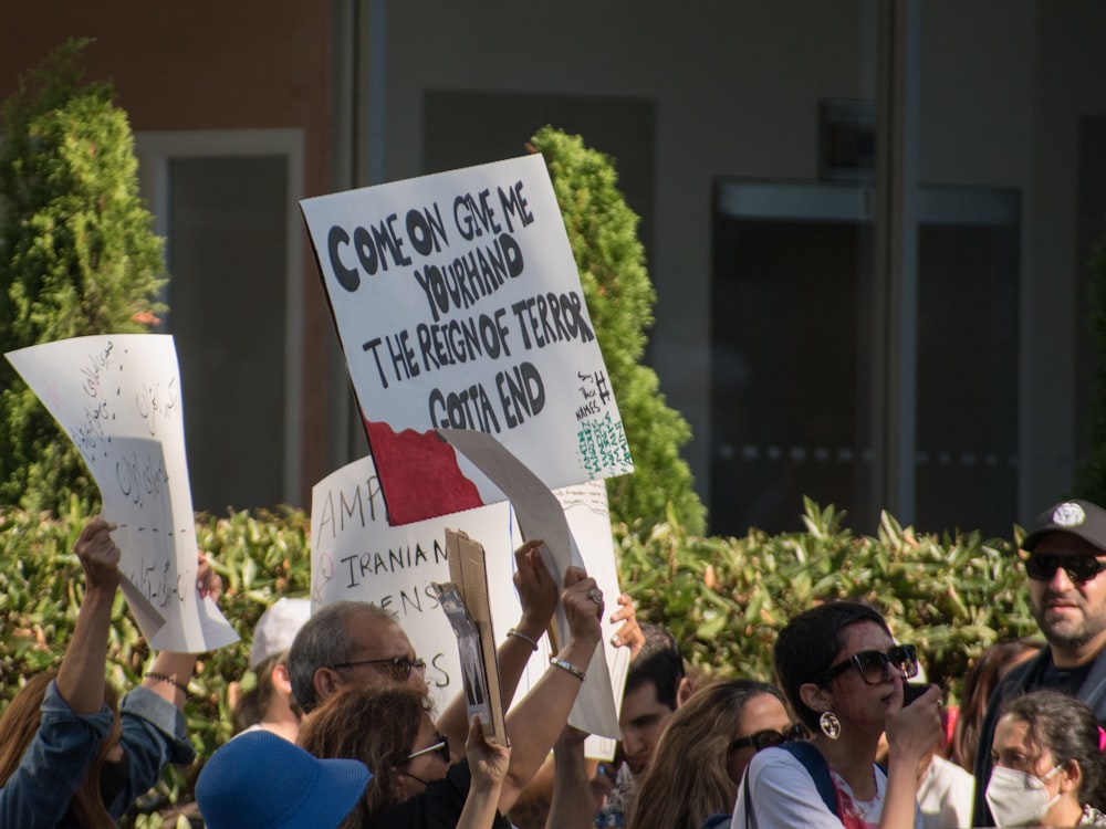 a group of people holding signs