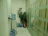 Office reception area with a Yadav Aqua water dispenser and employees chatting nearby.