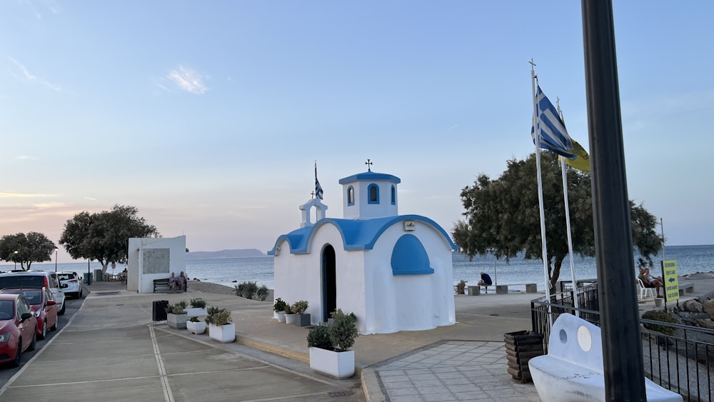 a white building with a flag on top and a flag on the side