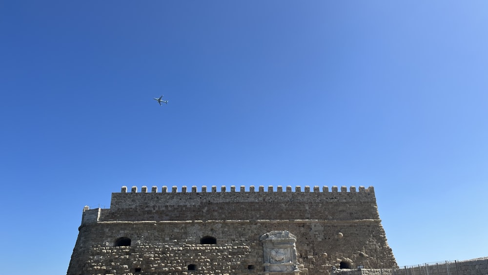 a plane flying over a castle