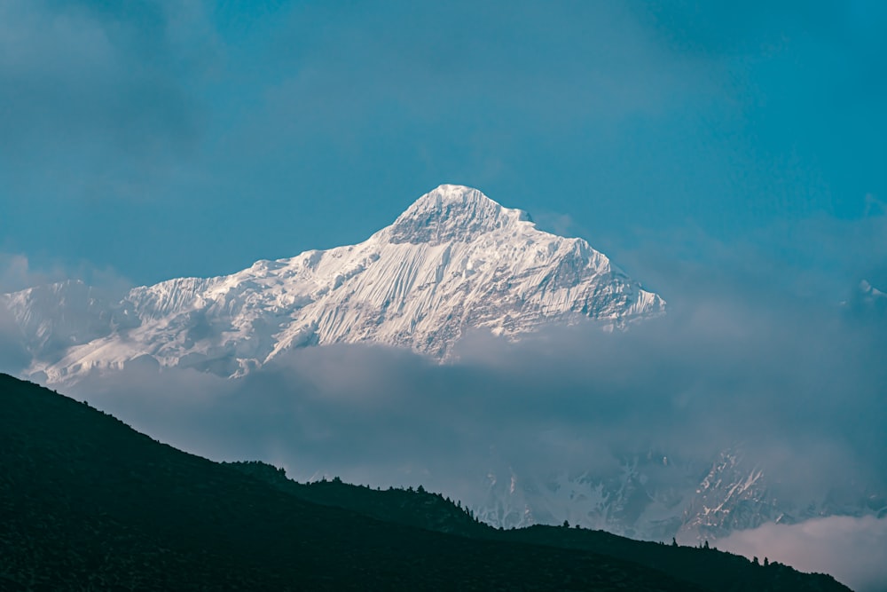 a mountain with clouds below