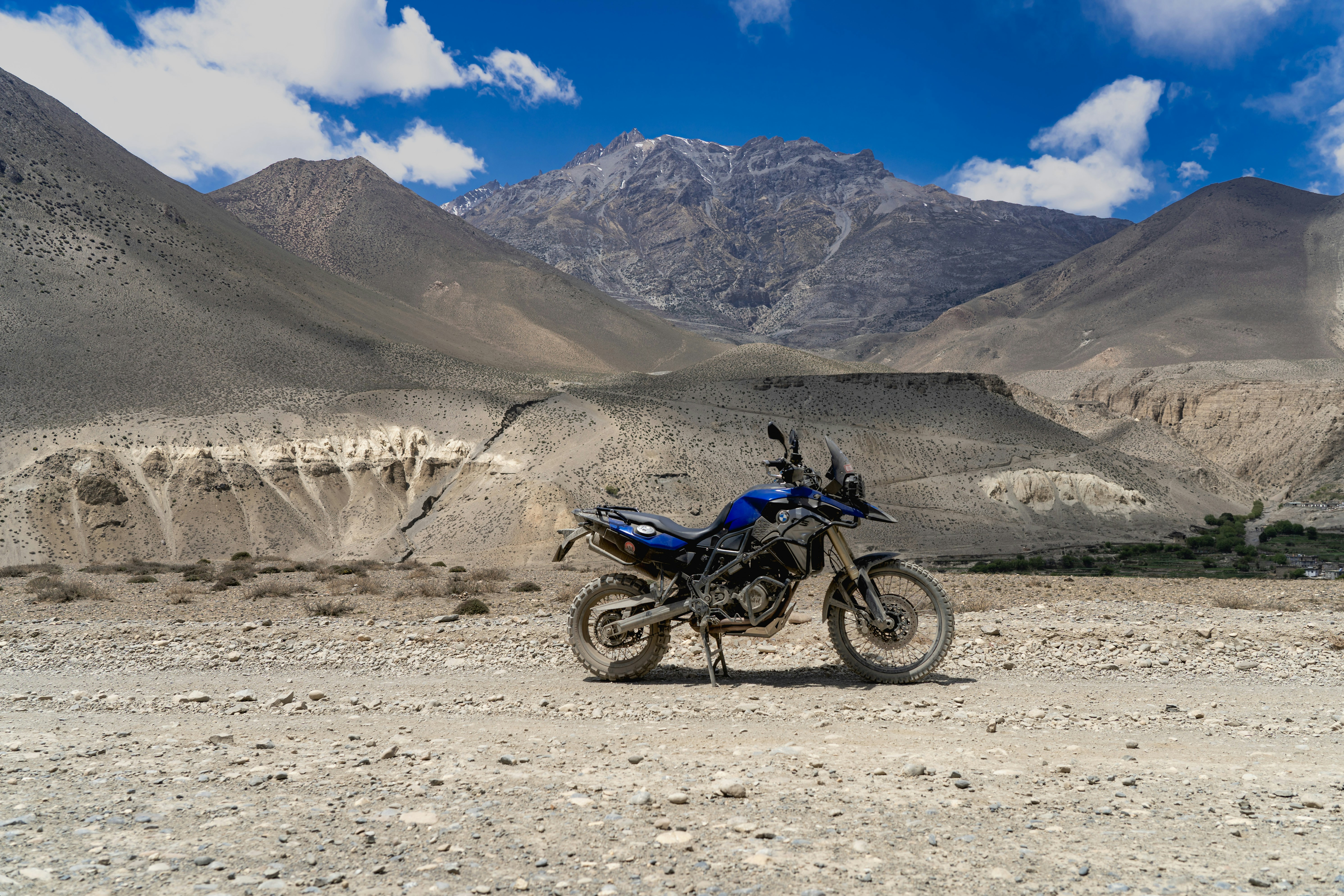 a motorcycle parked on a rocky area