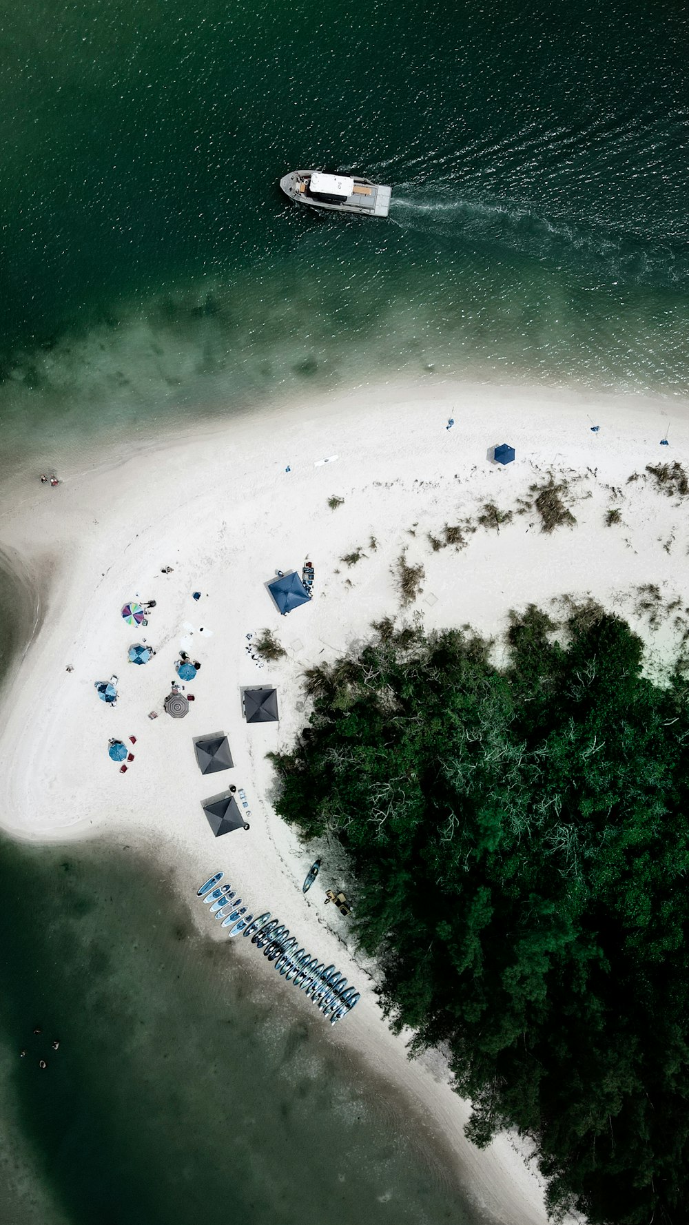 a beach with people and boats