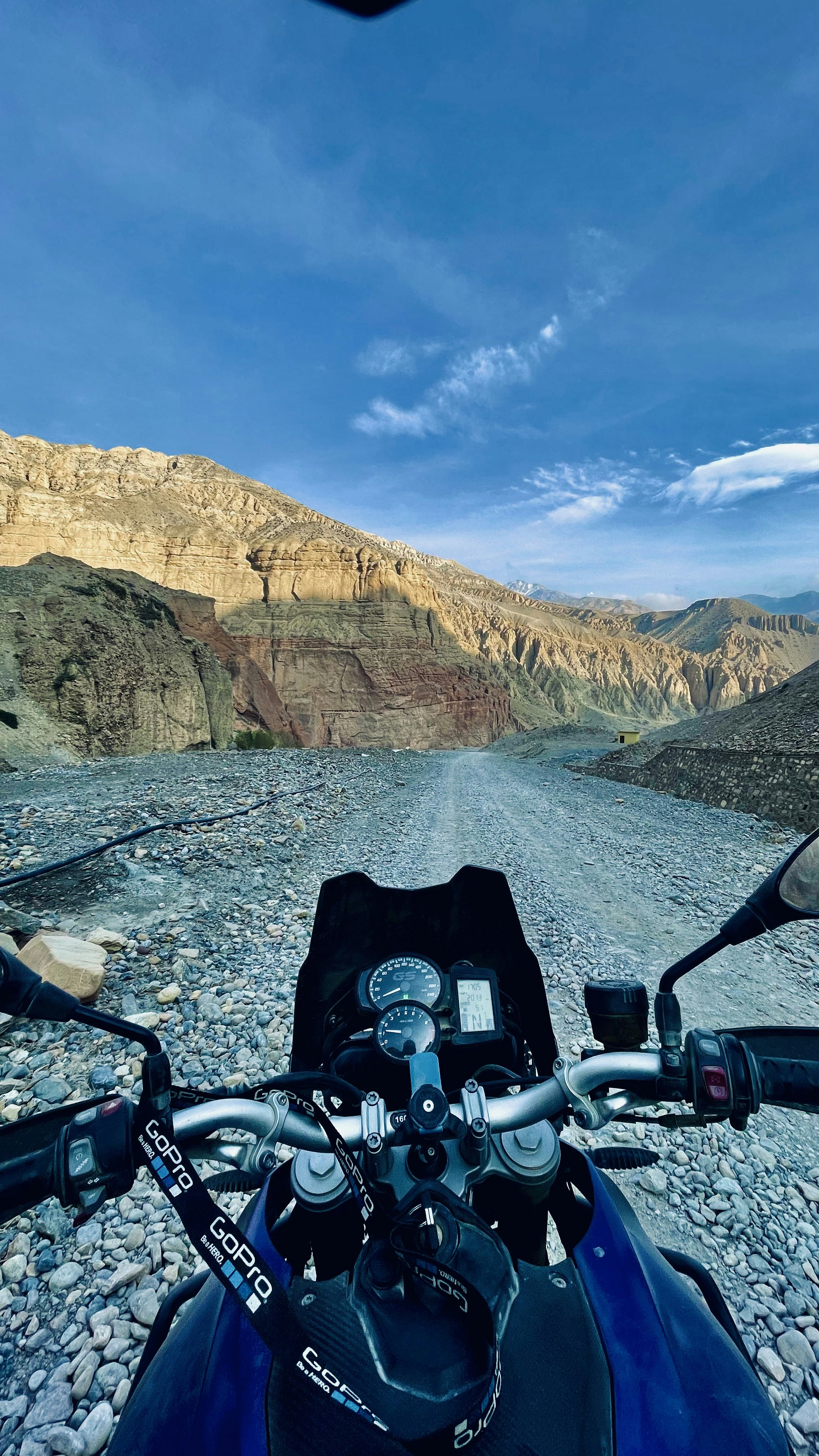 a motorcycle parked on a rocky road