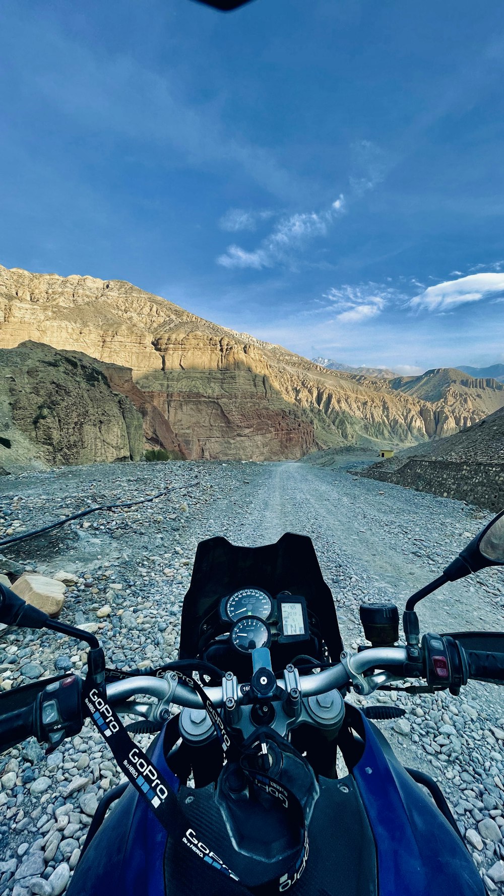 a motorcycle parked on a rocky road