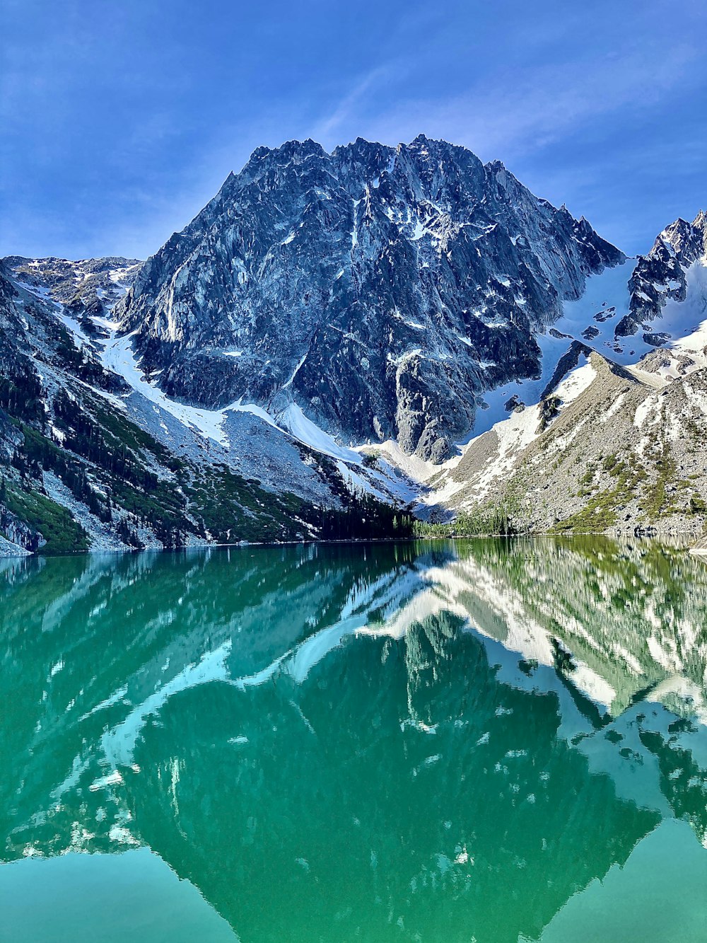 a body of water with mountains in the background