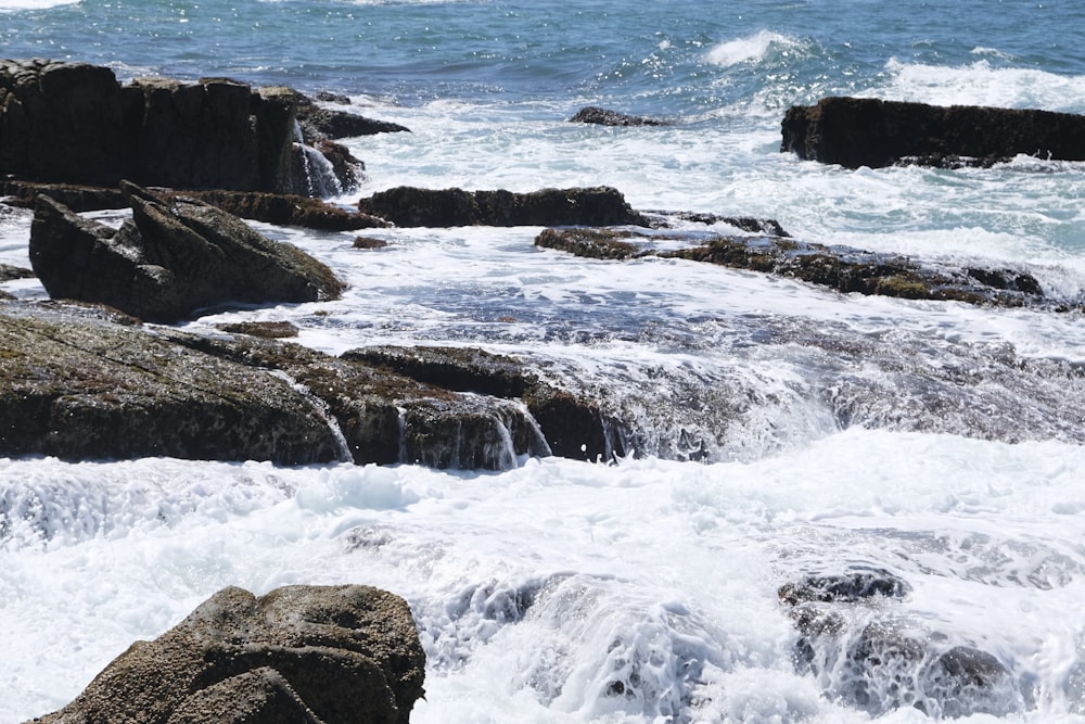 a rocky beach with waves crashing