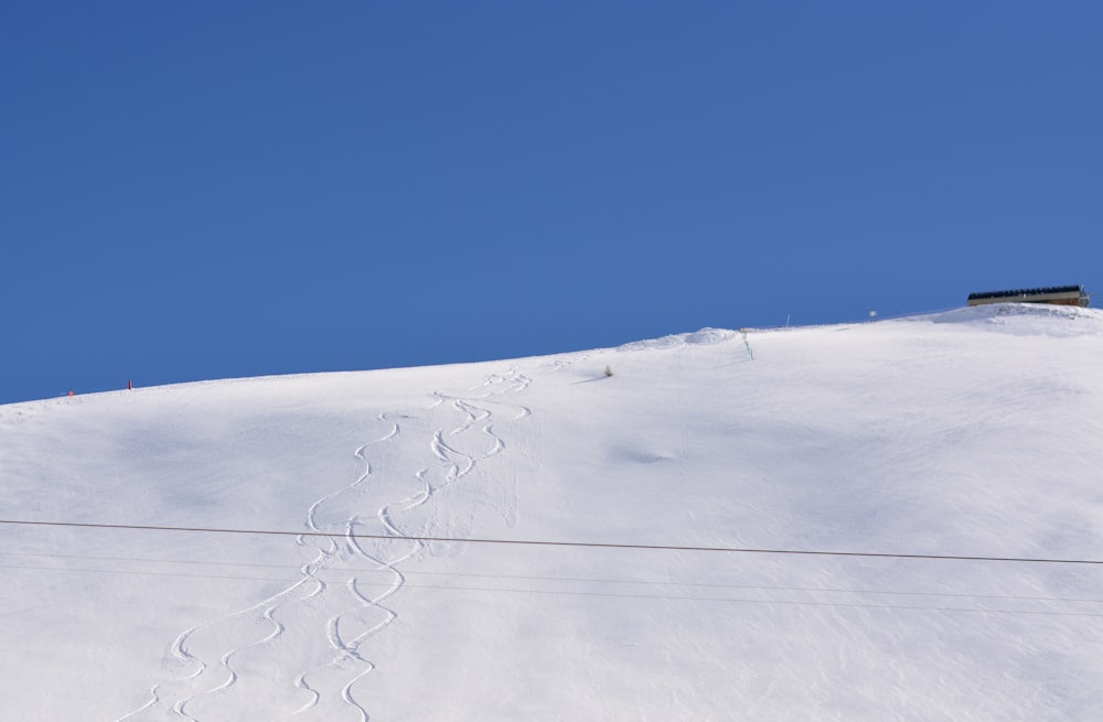 a snow covered hill with White Sands National Monument in the background