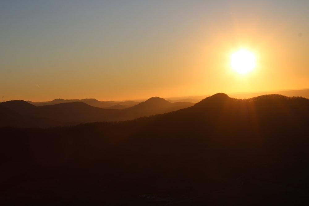 a sunset over a mountain range