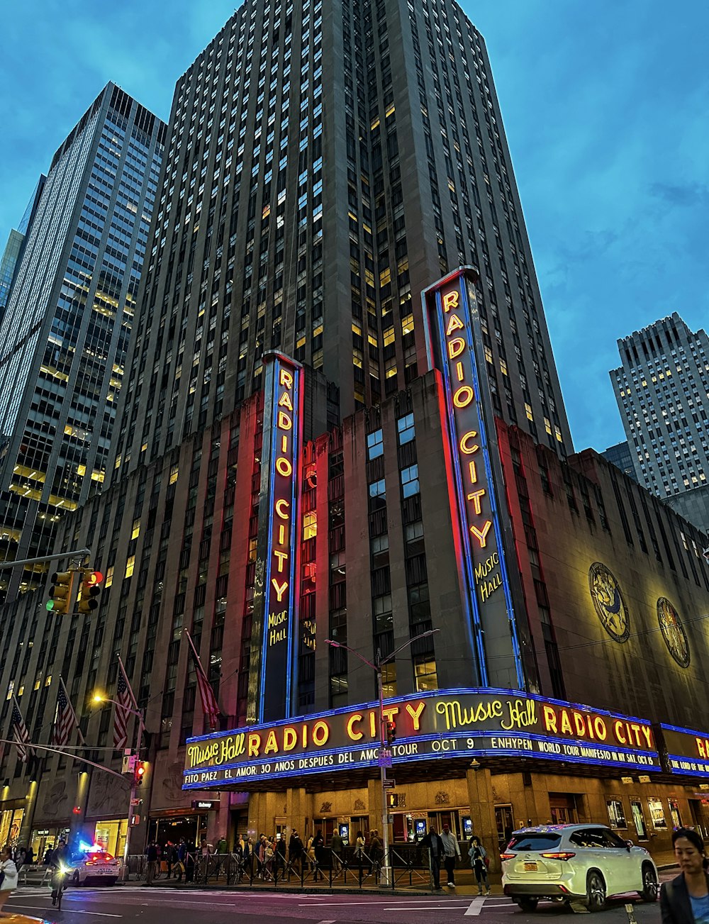 a large building with many windows with Radio City Music Hall in the background