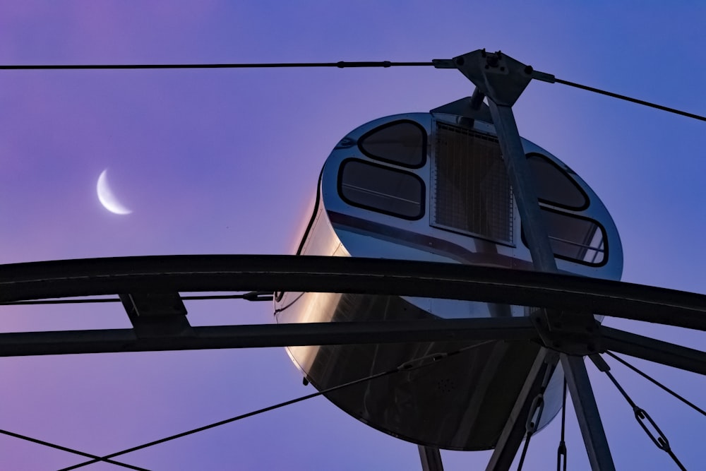 a satellite dish with a moon in the background