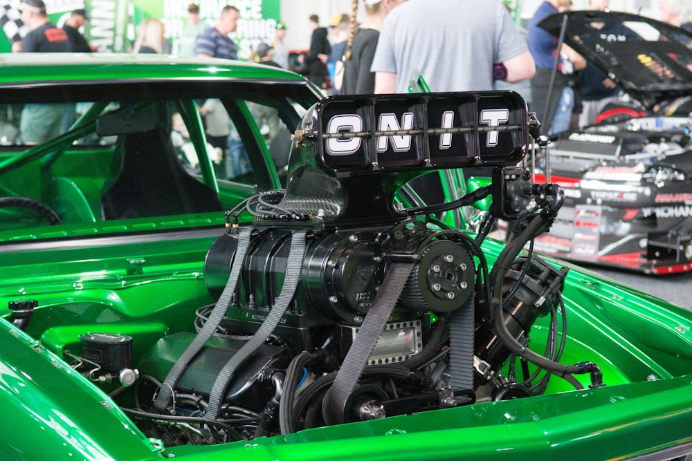 a green car with a large engine