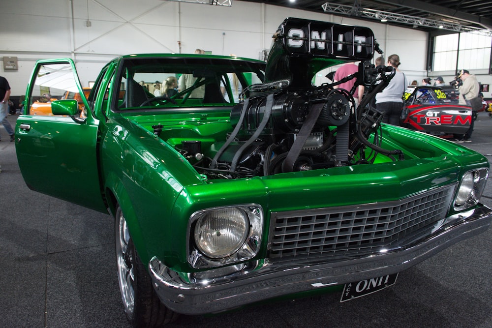 a green car with its hood open