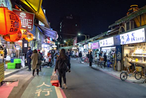 A bustling street market in Vietnam, alive with colorful lanterns and smiling locals.
