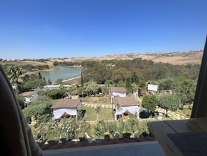 Suite balcony overlooking a scenic garden.