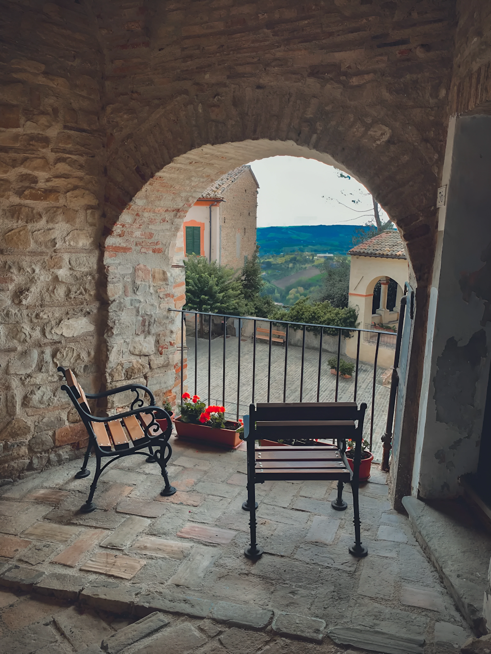 a couple of benches sit in a stone building