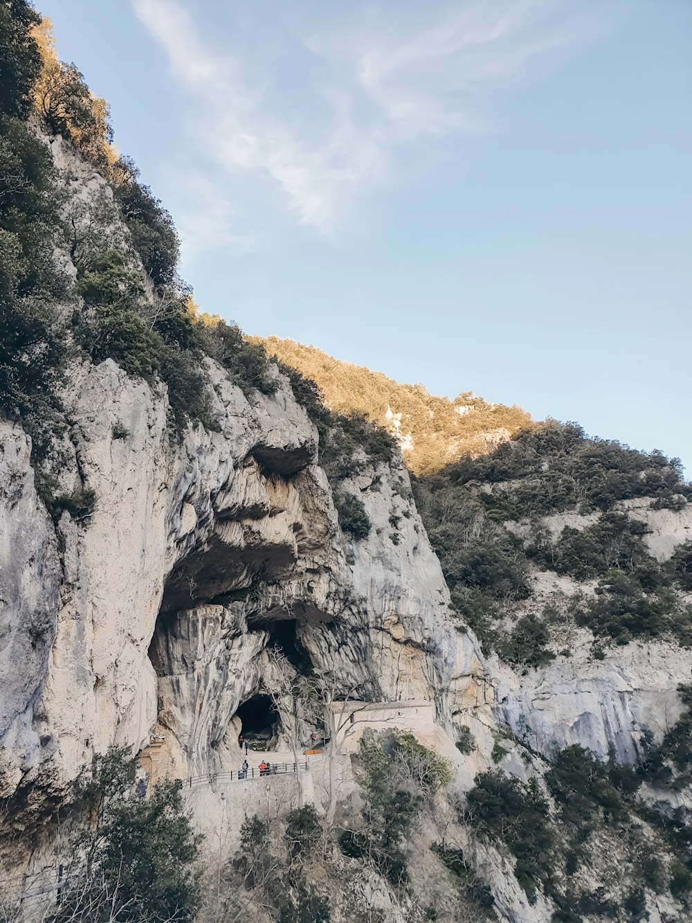 a cliff side with a cave