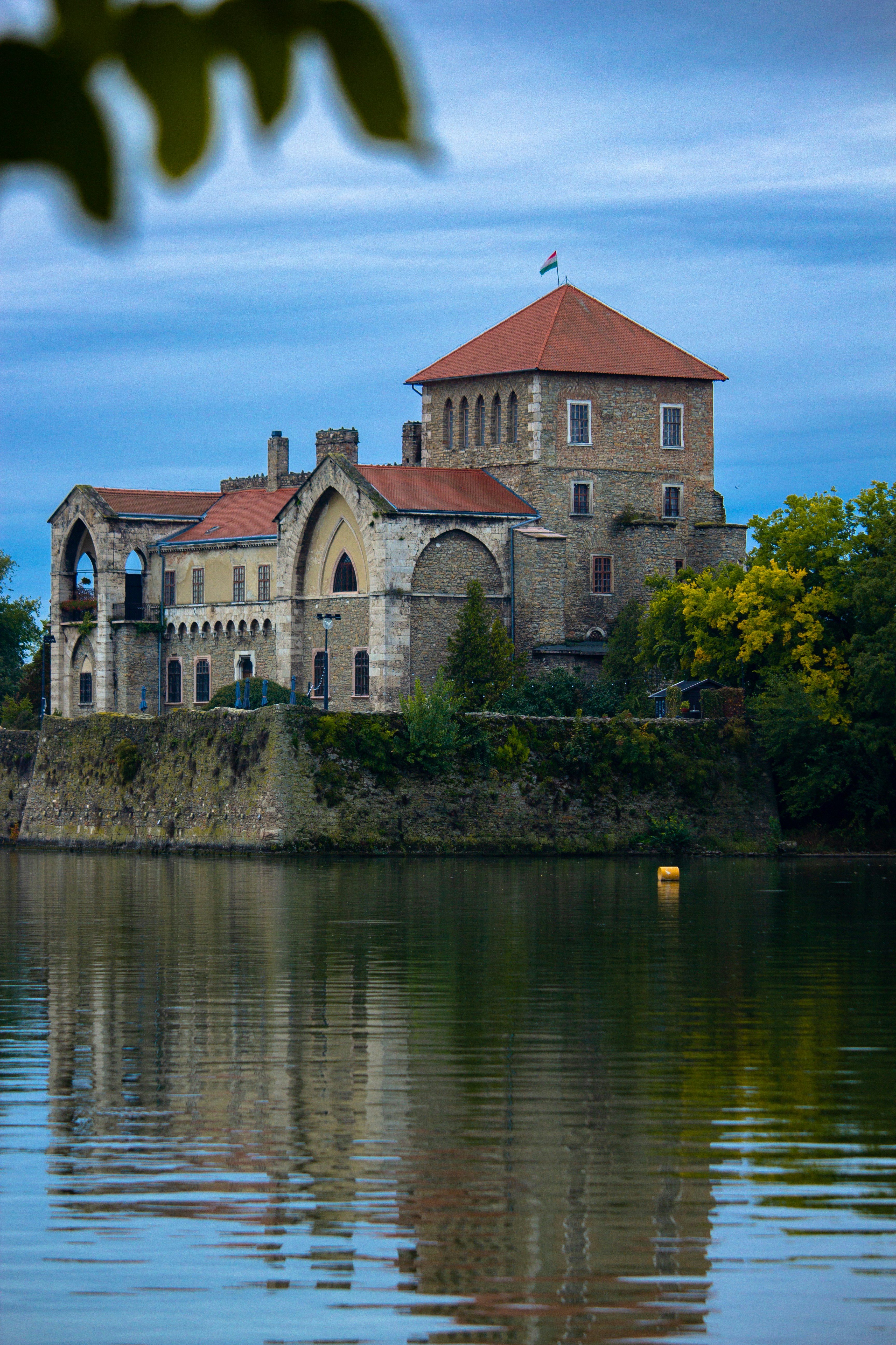 a building on a hill by water