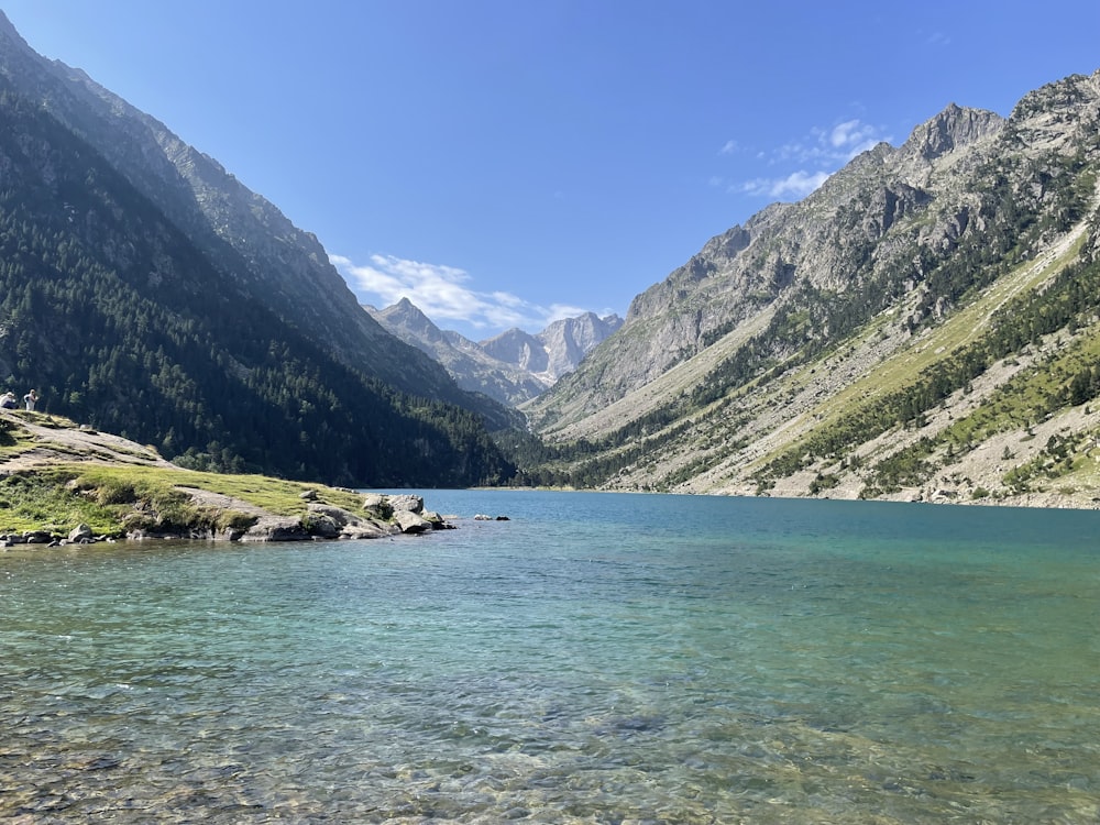 a body of water with mountains in the back